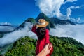 Women tourists holding man`s hand and leading him to PhaÃÂ dang viewpoint in Muang Ngoy, Laos